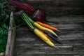 Colored organic carrots over rustic wooden background closeup. Top view Royalty Free Stock Photo