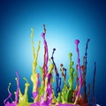 Colored paint splashes on blue background