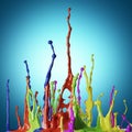 Colored paint splashes on blue background