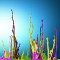 Colored paint splashes on blue background