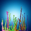 Colored paint splashes on blue background