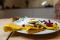 colored pancakes with berries, butter and honey