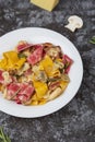 Colored papardelle with chicken, bacon and mushrooms