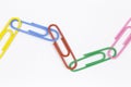 Colored paper clips on a white background Royalty Free Stock Photo