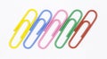 Colored paper clips on a white background Royalty Free Stock Photo