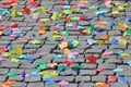 Colored paper flowers petals on a cubic stone background