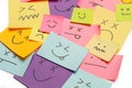 Colored paper notes with drawings of different face emotions on a white background Royalty Free Stock Photo