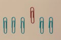 Colored paper red clip outstanding on pink background. minimal c