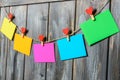 Colored paper sheets on thread with heart shaped clothespin wooden background Royalty Free Stock Photo