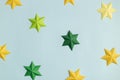 Colored paper stars over blue background