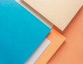 colored paper texture background in minimal composition with geometric shapes lines in pastel blue and peach and orange Royalty Free Stock Photo