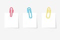 Colored paperclip with blank white notepaper.