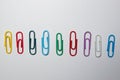 Colored paperclips on a white background. Royalty Free Stock Photo