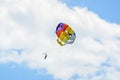 Colored parasail wing in the blue clouds sky, Parasailing