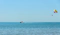 Colored parasail wing pulled by a boat in the sea water, Parasailing Royalty Free Stock Photo