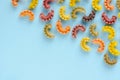 Colored pasta composition on blue background. Flat lay Royalty Free Stock Photo