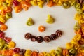 Colored pasta in the form of a spiral. Close-up of raw multi-colored rotini. Smiley. Smile pasta Royalty Free Stock Photo