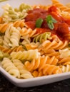 Colored pasta with tomato sauce on plate close up Royalty Free Stock Photo