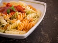 Colored pasta with tomato sauce on plate close up Royalty Free Stock Photo