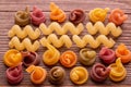 Colored pasta on wooden table