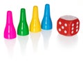 Colored pawns and red dice. Set pieces in the colors yellow, green, blue. Cube in red with white eyes.