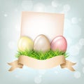 Colored pearl realistic Easter eggs in green grass