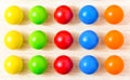 Colored pegs board, wood beads on wooden background. Shallow DOF