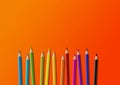 Colored pencil group isolated on orange. Horizontal background