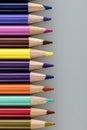 A stack of colored pencil points against a gray background Royalty Free Stock Photo