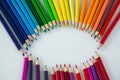 Colored pencils arranged in circle on white background Royalty Free Stock Photo