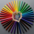 Colored pencils are arranged in a circular pattern on a gray background Royalty Free Stock Photo