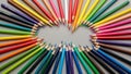 Colored pencils arranged in a circular pattern with the tips pointing inward, forming an empty oval Royalty Free Stock Photo