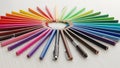 Of colored pencils is arranged in a circular pattern on a white Royalty Free Stock Photo