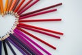 Colored pencils arranged in semi circle on white background Royalty Free Stock Photo