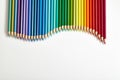 Colored pencils arranged in a wave shape Royalty Free Stock Photo