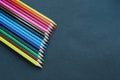 Colored pencils background.Color pencils on dark purple background.Close up. Many different colored pencils on dark purple Royalty Free Stock Photo