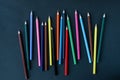 Colored pencils background.Color pencils on dark purple background.Close up. Many different colored pencils on dark purple Royalty Free Stock Photo