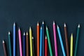 Colored pencils background.Color pencils on dark purple background.Close up. Many different colored pencils on dark purple Royalty Free Stock Photo