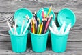 Colored pencils, ballpoint pens in pencil cases. A pencil case in the form of a trash can. On brushed pine boards painted black Royalty Free Stock Photo