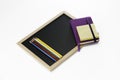 Colored pencils, black board, notebook and memopad Royalty Free Stock Photo
