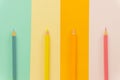 Colored pencils Blue, yellow, orange and pink on Blue, yellow, orange and pink background. Royalty Free Stock Photo