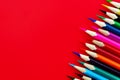 Colored pencils on a bright red background Royalty Free Stock Photo