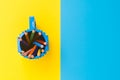 Colored pencils in a bucket on blue and yellow background. Back to scool concept . Royalty Free Stock Photo