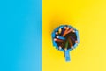 Colored pencils in a bucket on blue and yellow background. Back to scool concept . Royalty Free Stock Photo