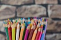 Close up of colored pencils in front of a blurred wall