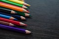 Colored pencils on dark background Royalty Free Stock Photo