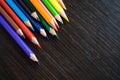 Colored pencils on dark background Royalty Free Stock Photo