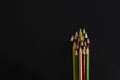 Colored pencils of different lengths for drawing on a black background. For study or entertainment. Horizontal close-up Royalty Free Stock Photo