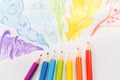 Colored pencils drawing rainbow smoke. Flat lay Royalty Free Stock Photo