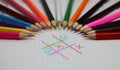Colored pencils and game crosses and zeroes Royalty Free Stock Photo